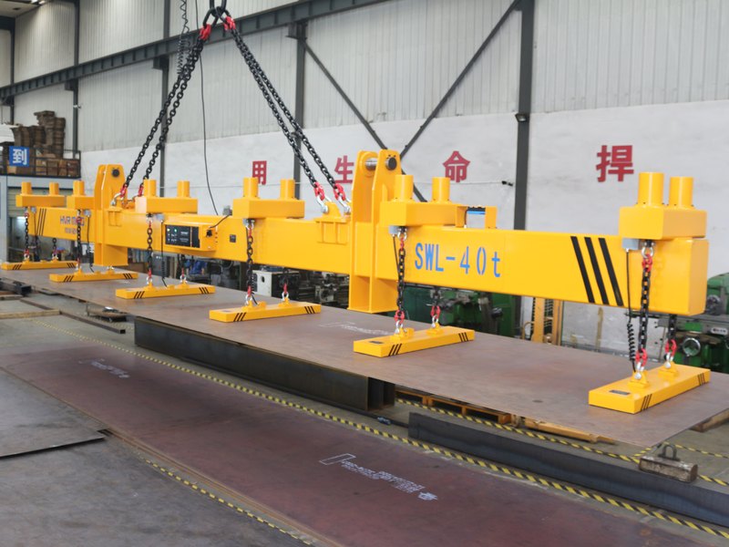 Electro-permanent lifting magnet holding a steel plate on a workshop crane